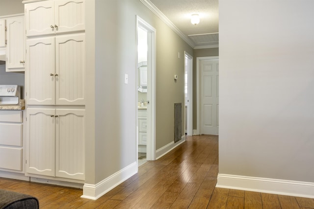  - corridor with baseboards, a textured ceiling, crown molding, and wood-type flooring