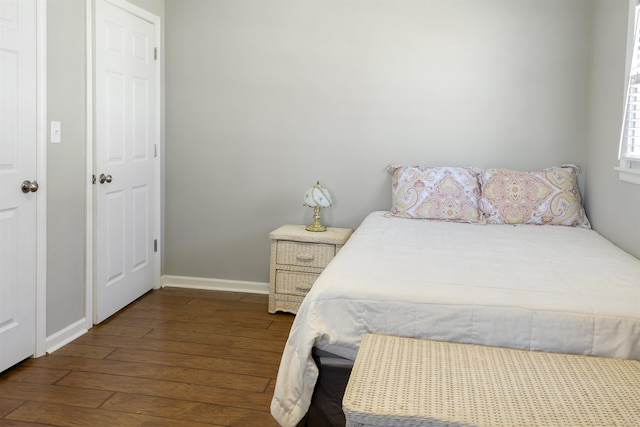  - bedroom with baseboards and wood finished floors