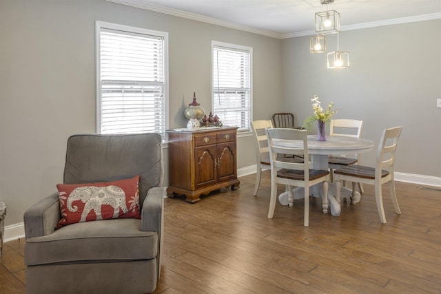  - dining space with visible vents, crown molding, baseboards, and wood finished floors