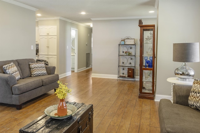  - living room with baseboards, light wood-style flooring, and crown molding