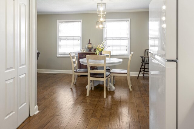  - dining room featuring baseboards, crown molding, and dark wood-style flooring