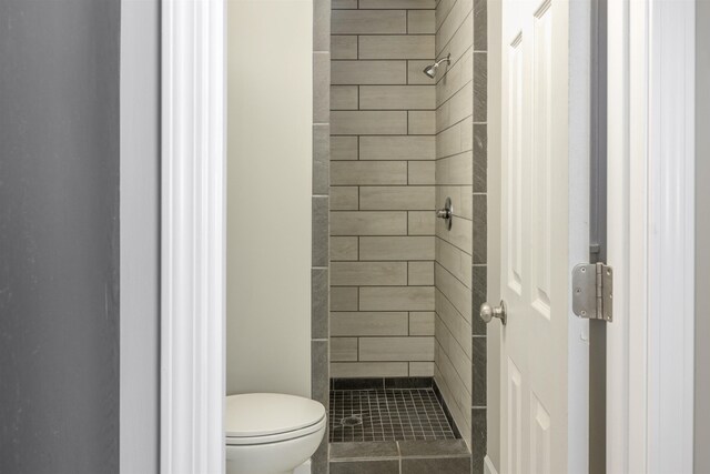  - bathroom featuring toilet and a stall shower