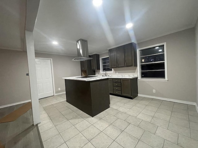 kitchen with light tile patterned floors, dark brown cabinetry, island range hood, ornamental molding, and a kitchen island