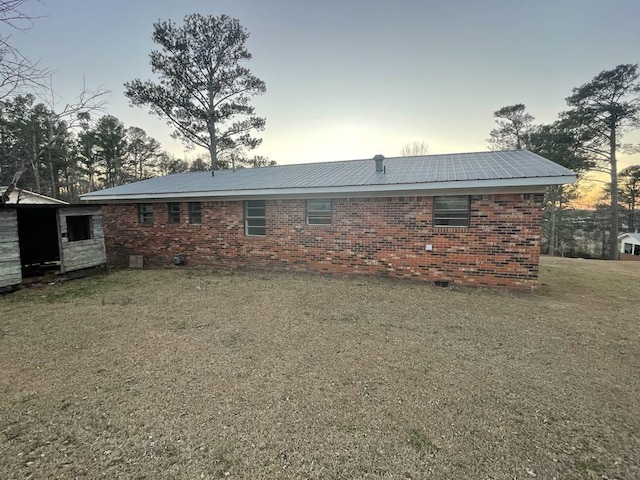 back house at dusk with a yard