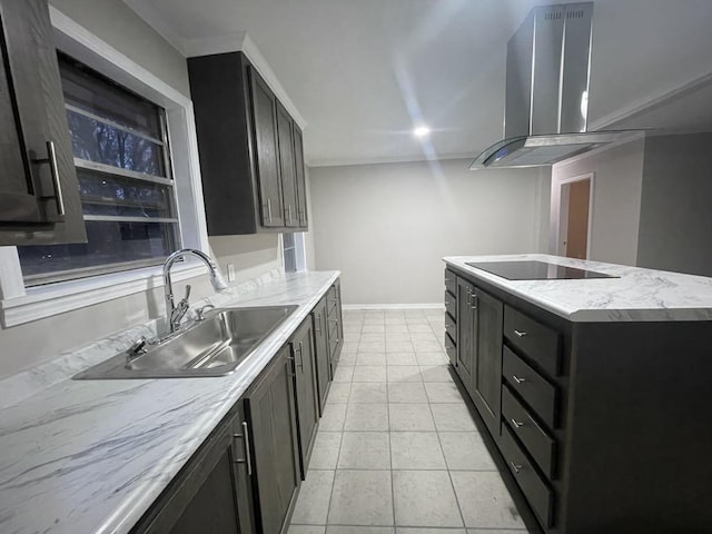 kitchen featuring an island with sink, sink, black electric stovetop, light tile patterned floors, and wall chimney exhaust hood