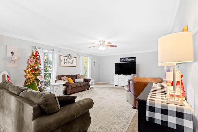 living room featuring ceiling fan, light colored carpet, and ornamental molding