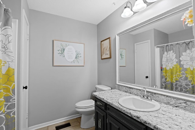 bathroom featuring toilet and vanity