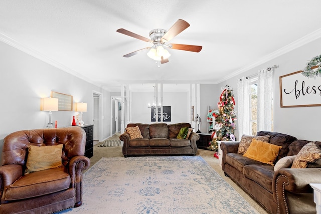 carpeted living room featuring ceiling fan with notable chandelier and ornamental molding