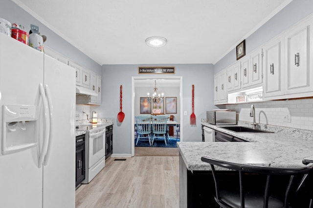 kitchen with white cabinetry, kitchen peninsula, white appliances, a chandelier, and pendant lighting