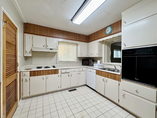  - kitchen with black appliances, light countertops, under cabinet range hood, and white cabinets