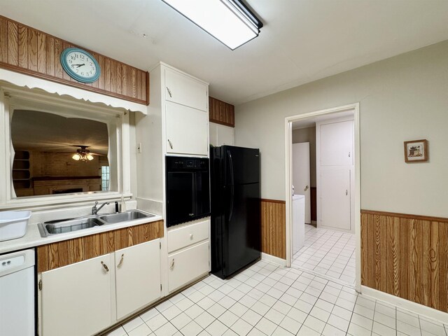  - kitchen featuring black appliances, wainscoting, light countertops, white cabinetry, and ceiling fan