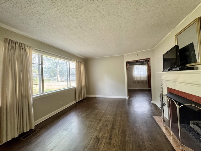  - unfurnished living room featuring a fireplace with flush hearth, ornamental molding, healthy amount of natural light, and wood finished floors