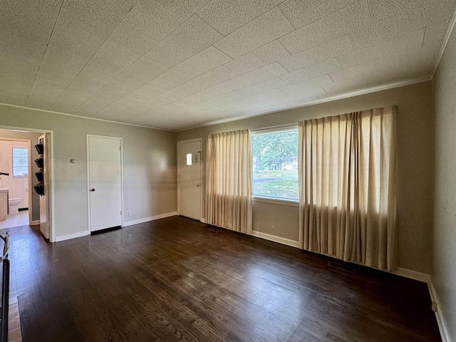  - unfurnished living room with dark wood finished floors and healthy amount of natural light