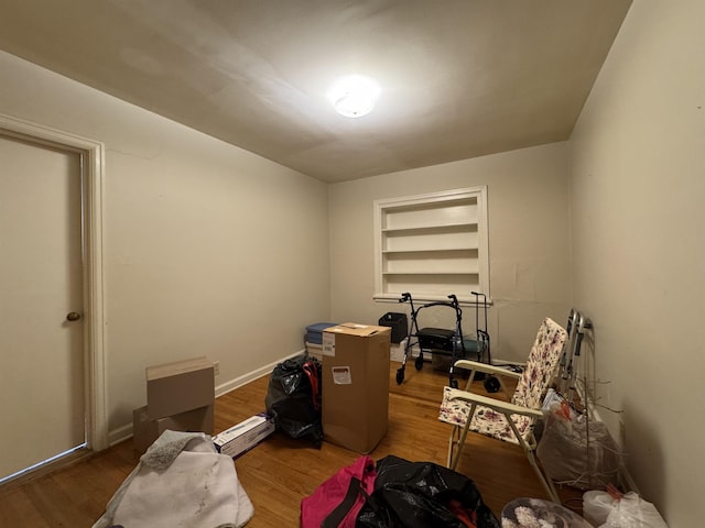  - miscellaneous room with wood finished floors and built in features