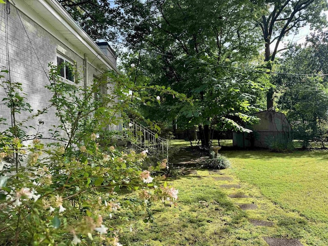  - view of grassy yard featuring a storage unit