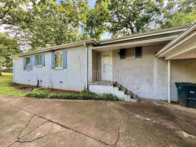  - view of front facade with crawl space and brick siding