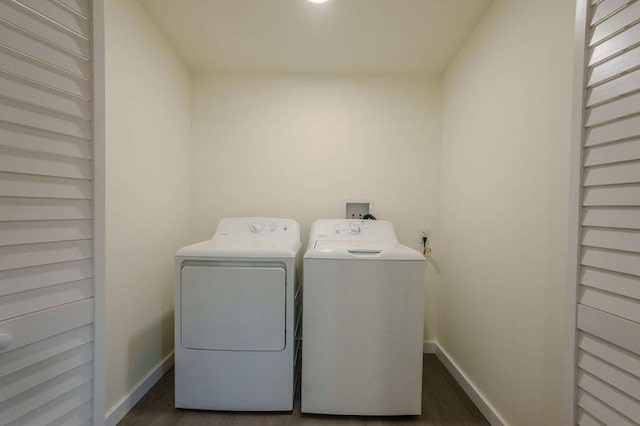  - laundry area featuring washing machine and clothes dryer and dark wood-type flooring
