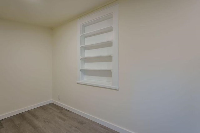  - unfurnished room featuring wood finished floors and baseboards