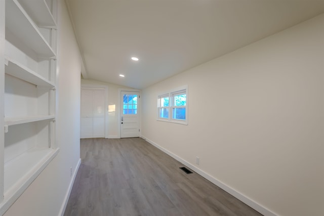  - foyer entrance with lofted ceiling, wood finished floors, and recessed lighting
