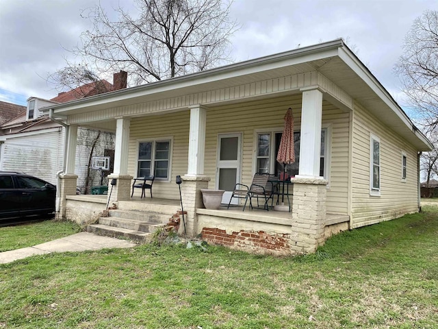 view of front of property with covered porch and a front yard