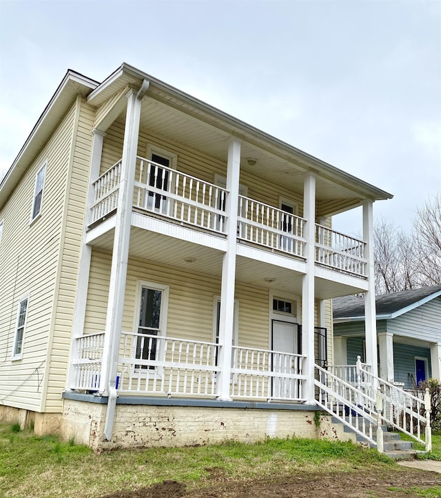 exterior space with a porch and a balcony