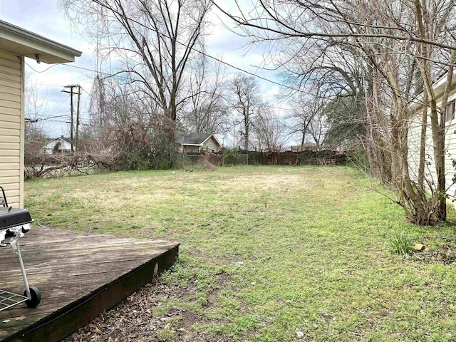 view of yard featuring fence and a wooden deck