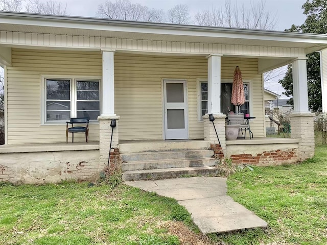 view of exterior entry featuring covered porch