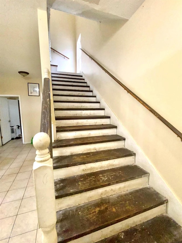 stairs with tile patterned flooring