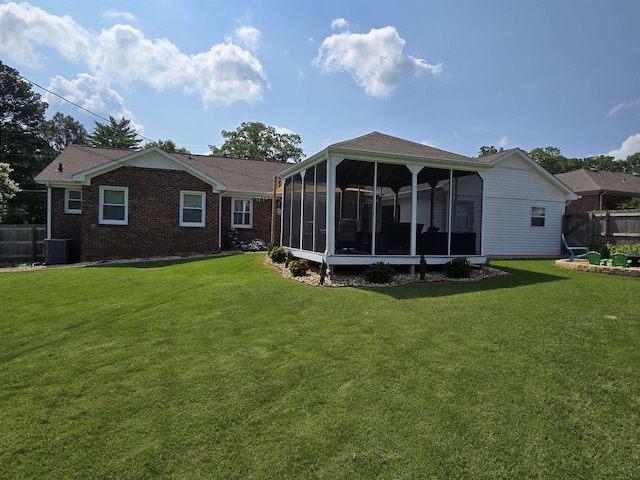  - rear view of house with a sunroom and brick siding