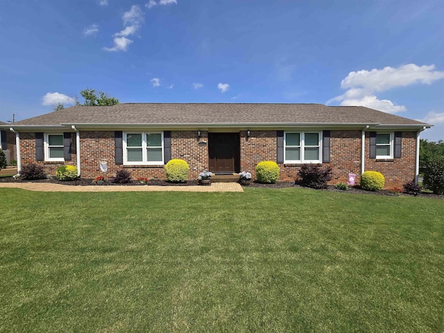  - single story home featuring a front yard, brick siding, and roof with shingles