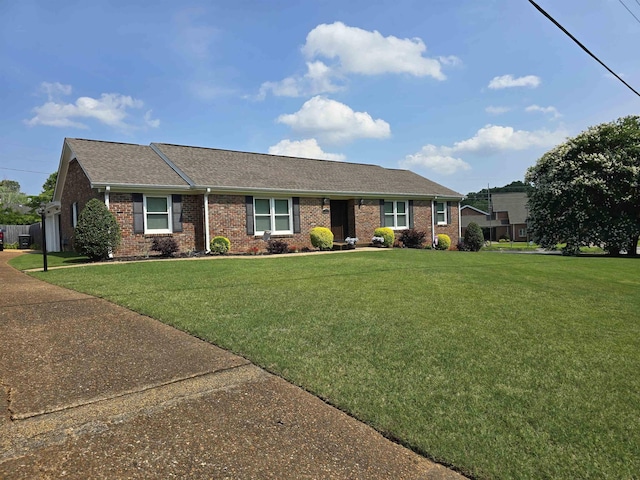  - single story home featuring brick siding, a front lawn, and roof with shingles