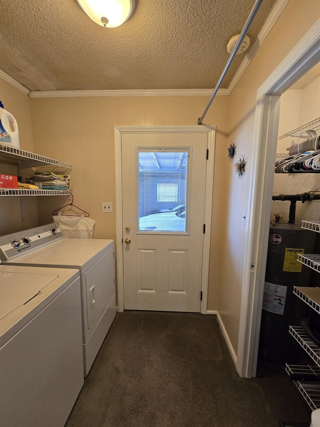  - washroom with washing machine and dryer, crown molding, dark colored carpet, and a textured ceiling