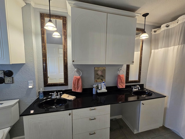  - full bath featuring double vanity, tile patterned flooring, and a textured wall