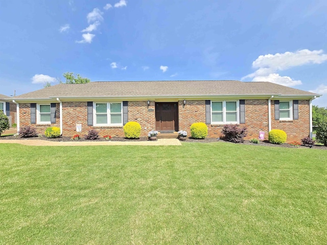  - ranch-style home with a front lawn and brick siding