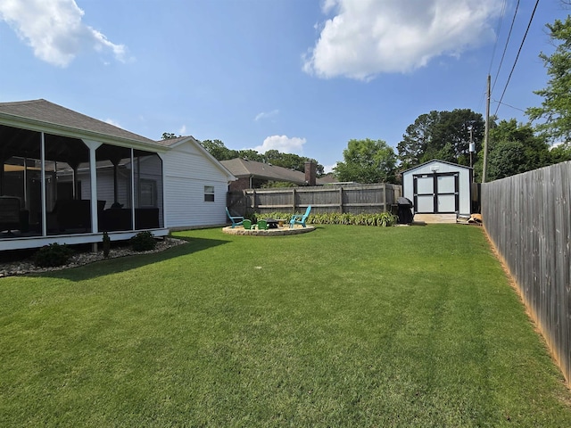  - fenced backyard with a storage shed, a fire pit, and a sunroom