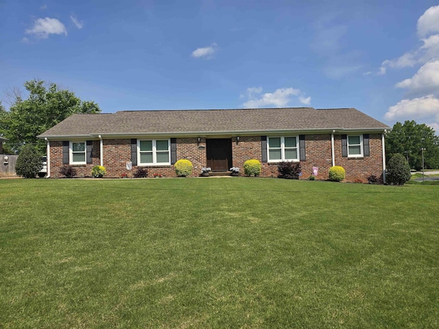  - ranch-style home featuring a front yard, brick siding, and roof with shingles