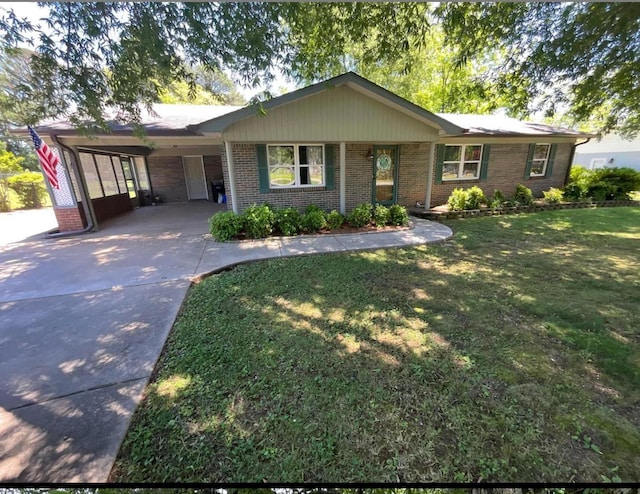 - ranch-style house featuring driveway, brick siding, an attached carport, and a front lawn