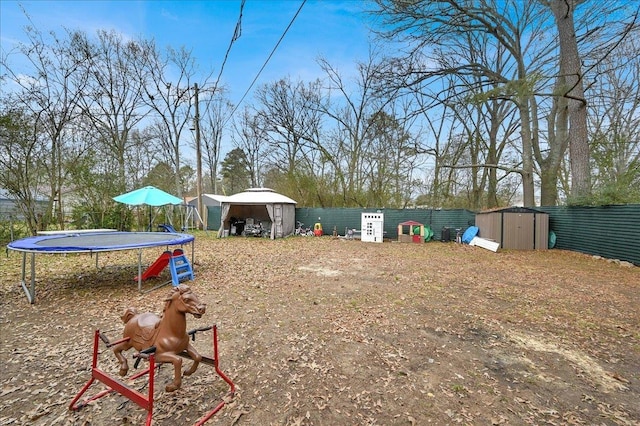 view of yard featuring a shed and a trampoline