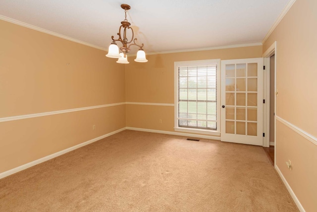 spare room featuring baseboards, carpet floors, and crown molding