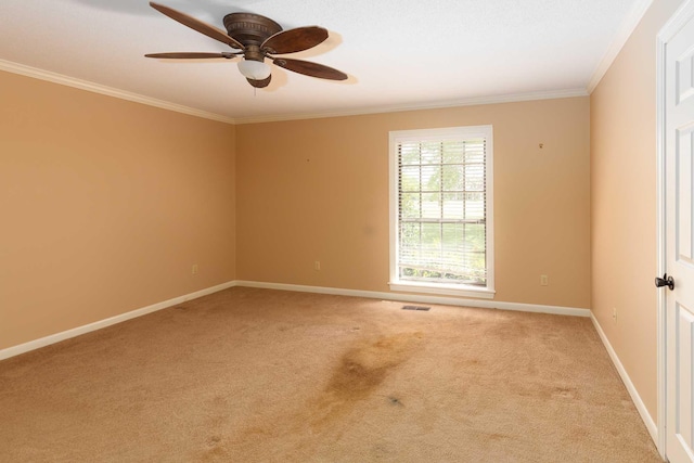 unfurnished room with crown molding, ceiling fan, light carpet, baseboards, and visible vents