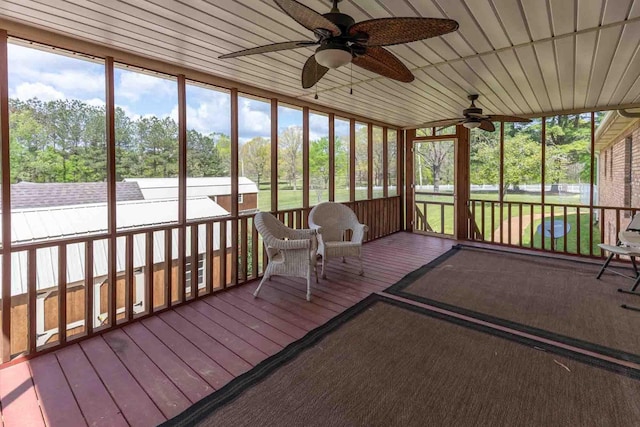 sunroom / solarium featuring a wealth of natural light and a ceiling fan