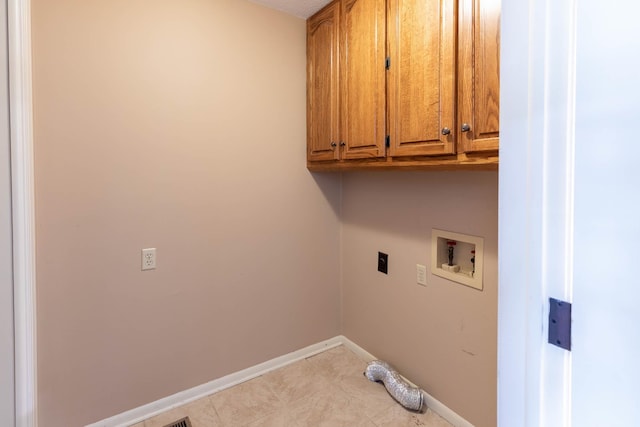 washroom with electric dryer hookup, light tile patterned flooring, cabinet space, baseboards, and washer hookup