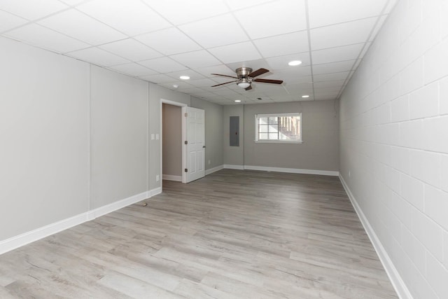 unfurnished room with recessed lighting, light wood finished floors, electric panel, baseboards, and ceiling fan