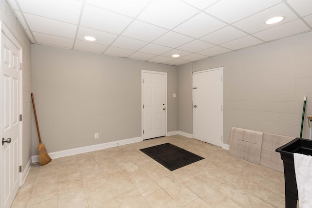 entryway with light tile patterned floors, baseboards, a paneled ceiling, and recessed lighting