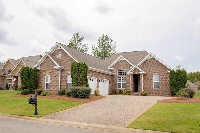 view of front of home with a front yard and a garage