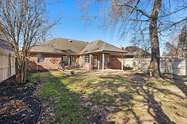 back of house with a patio and a yard