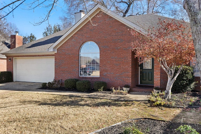 view of front of house with a garage and a front lawn