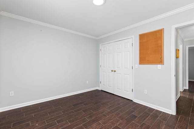 unfurnished bedroom with crown molding and a closet