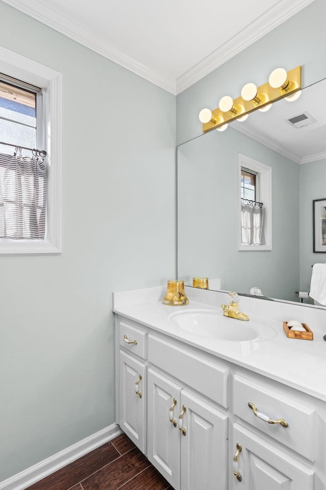 bathroom featuring hardwood / wood-style flooring, vanity, and ornamental molding