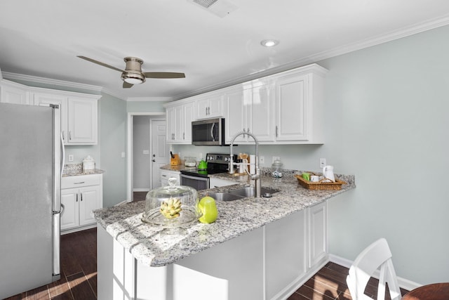 kitchen featuring white cabinetry, appliances with stainless steel finishes, dark hardwood / wood-style floors, and kitchen peninsula